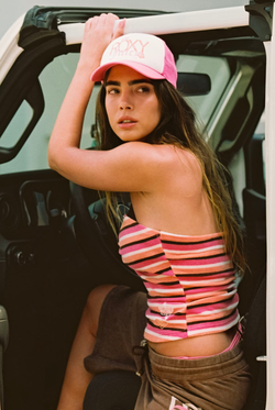 Displays a model wearing the azalea pink Roxy and juicy Couture trucker cap 