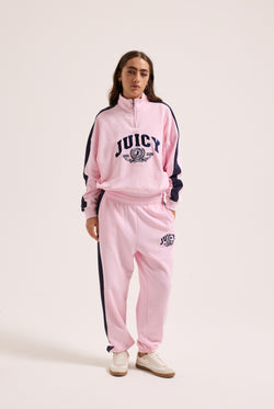 Displays a model wearing the Cherry Blossom 'Juicy' branded college crest track top  
