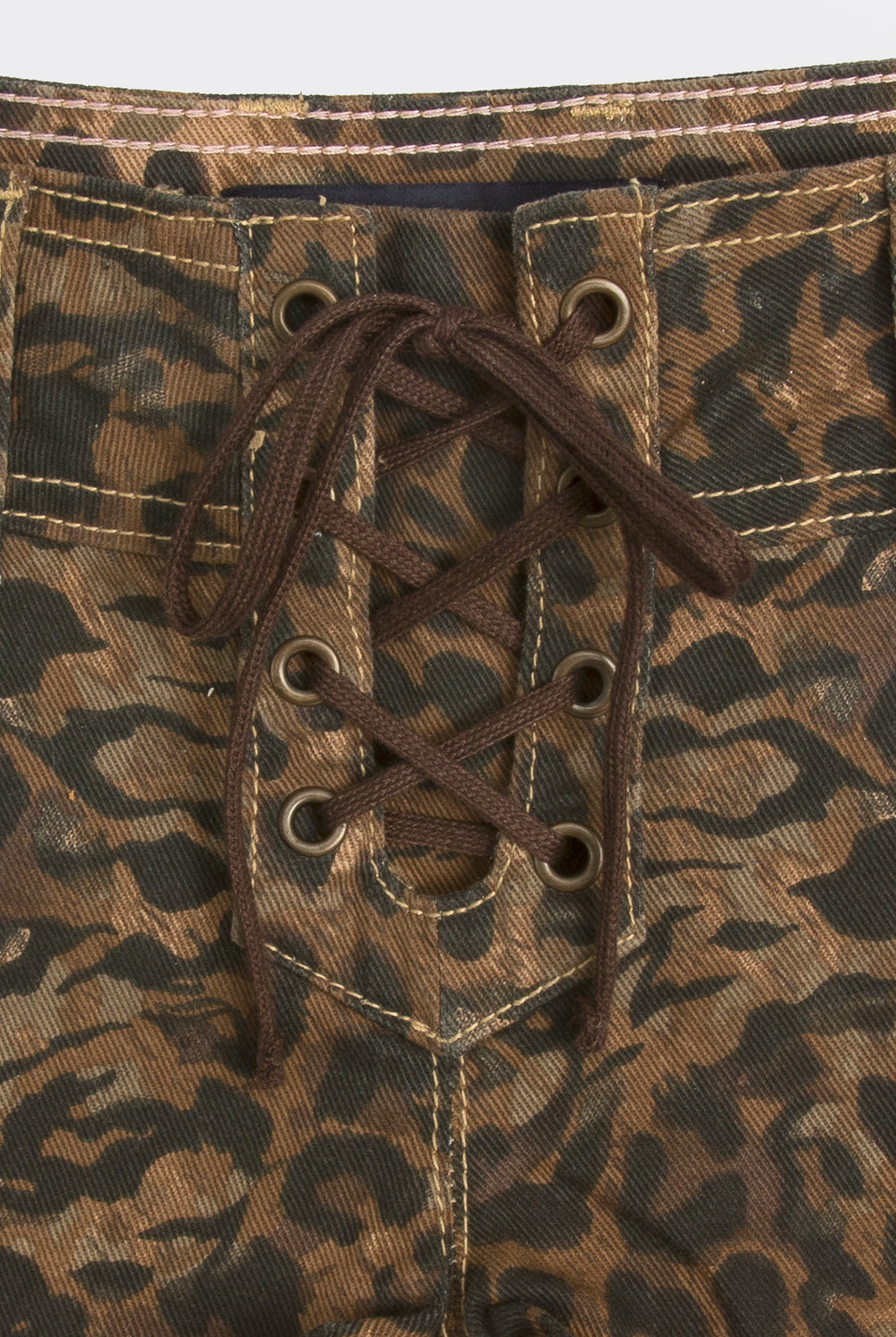 Displays the animal 'Juicy' branded denim lace up shorts featuring the close up on the lace