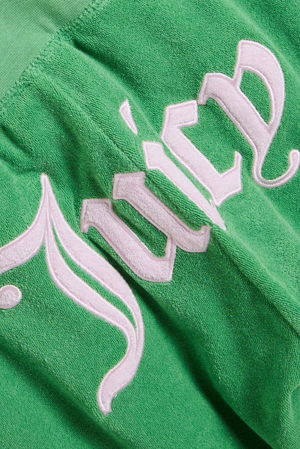 Displays the peppermint appliqué 'Juicy' branded Terry ultra low track pants featuring the juicy branding 