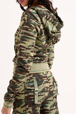 Displays a model wearing the Camo Print 'Juicy' branded washed cotton hoodie 