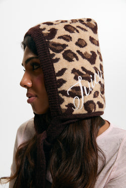 Displays a model wearing the Leopard Print 'Juicy' branded Bonnet With Bow