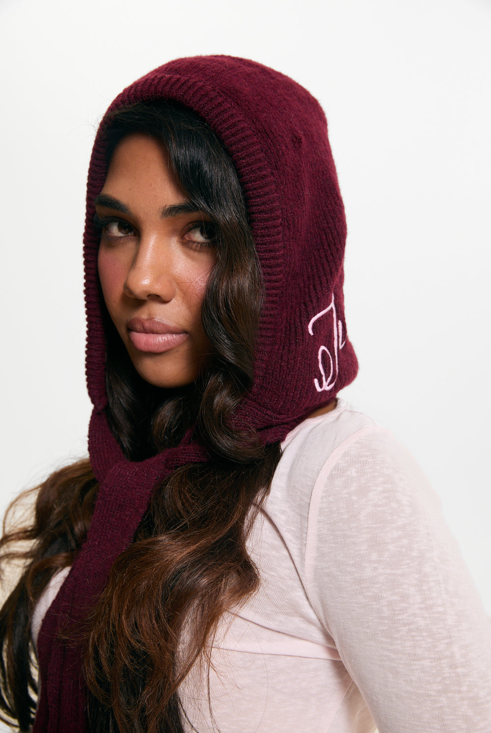 Displays a model wearing the Burgundy 'Juicy' branded Bonnet With Bow