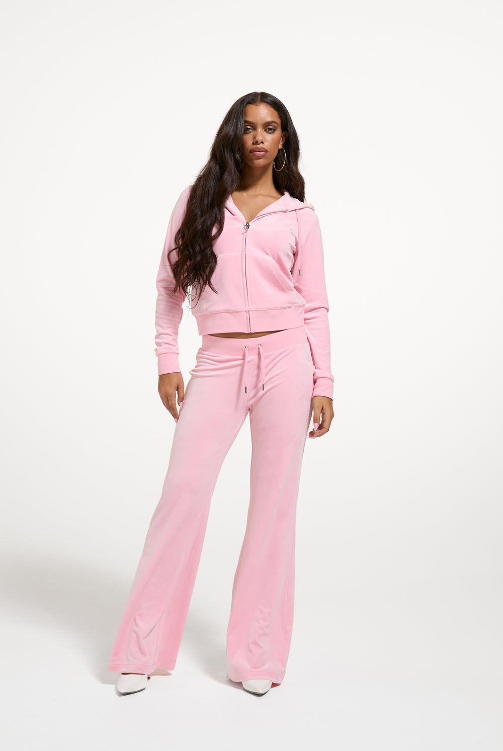 Displays a model wearing the Juicy Pink 'Juicy' branded bridesmaid classic velour hoodie 