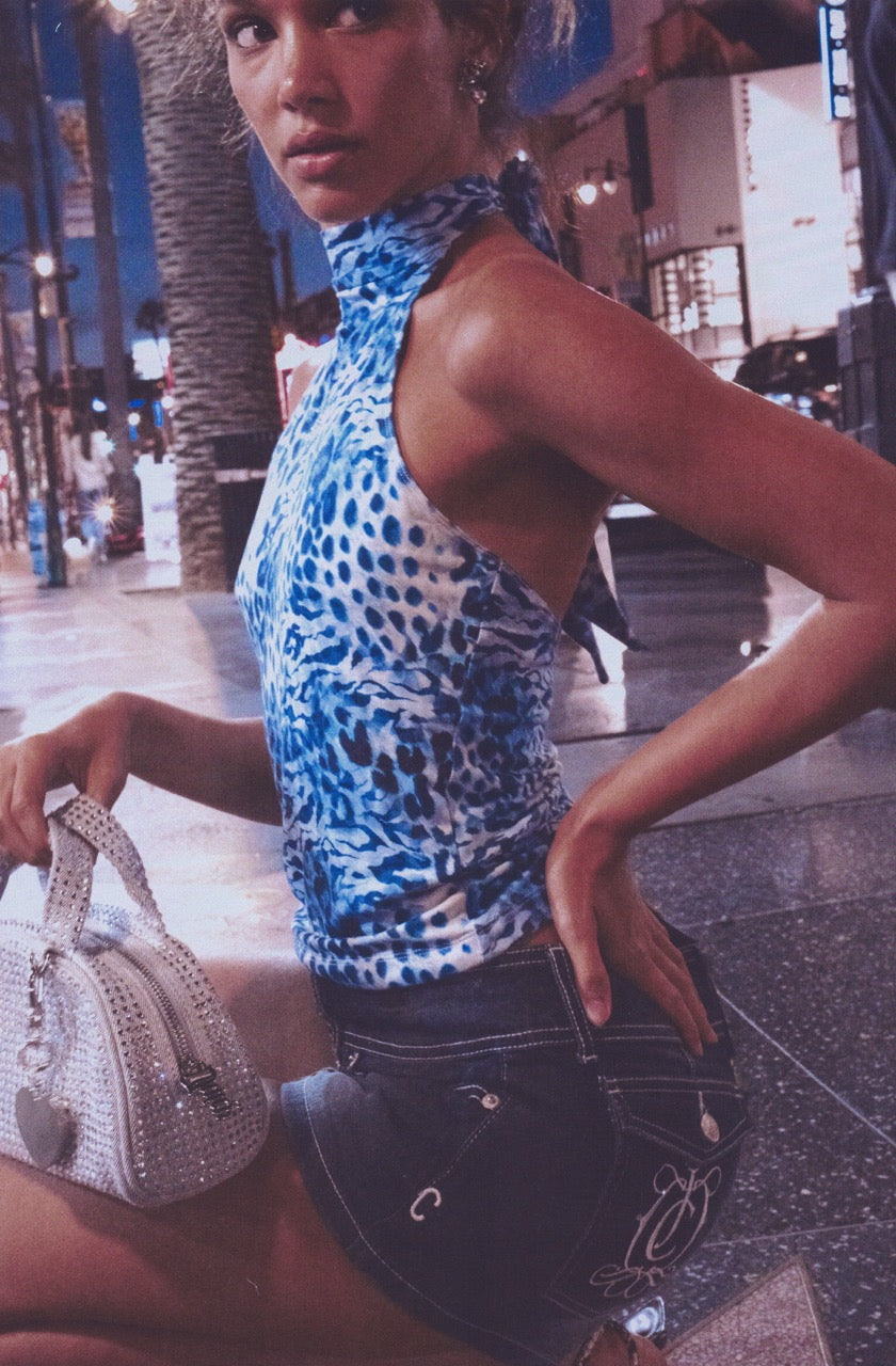 Displays a model wearing the Blue Leopard Print 'Juicy' branded jersey halter neck top 