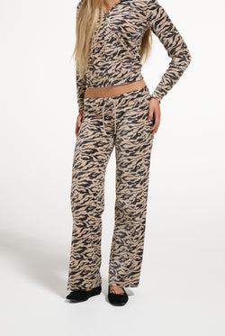 Displays a model wearing the Camo Zebra 'Juicy' branded Washed Og Straight Trackpant