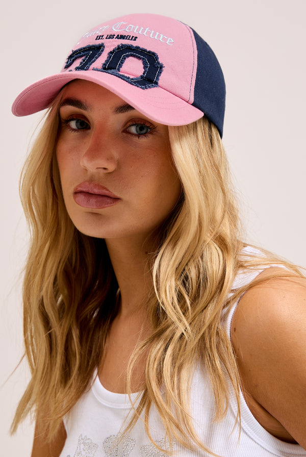 Displays a model wearing the Pink/Night Sky 'Juicy' branded sky cap 