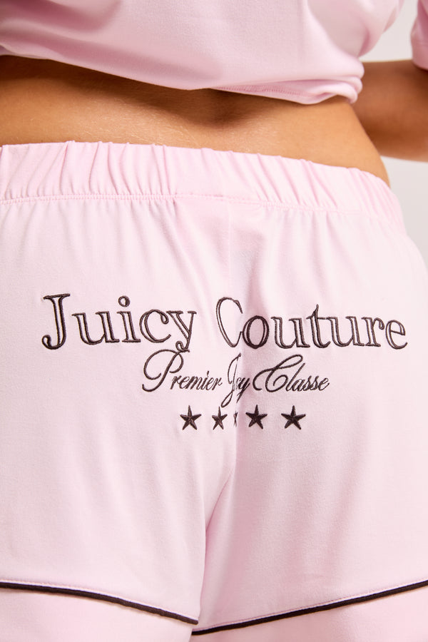 Displays a model wearing the Cherry Blossom 'Juicy' branded chateau shorts included in the pyjama set