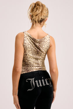 Displays a model wearing the natural cheetah print 'Juicy' off the shoulder top 