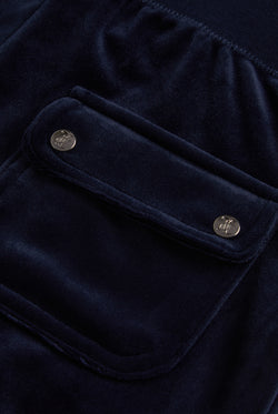 Juicy Couture Navy velour tracksuit bottoms - close up of the back pocket with two silver branded poppers