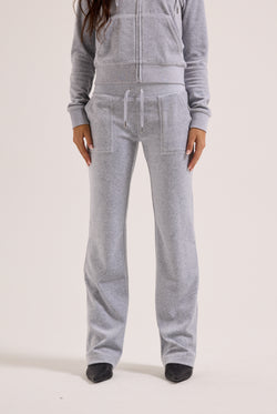 Person wearing a gray tracksuit on a white background