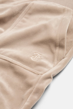 Displays the String 'Juicy' branded classic velour del ray pocketed bottoms featuring the close up on the juicy Couture branding 