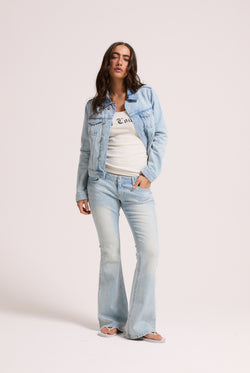 Displays a model wearing the light wash 'Juicy' branded Diamanté low rise flare jeans 