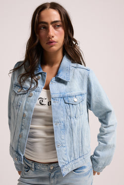 Displays a model wearing the light wash 'Juicy' branded stretch denim fitted jacket