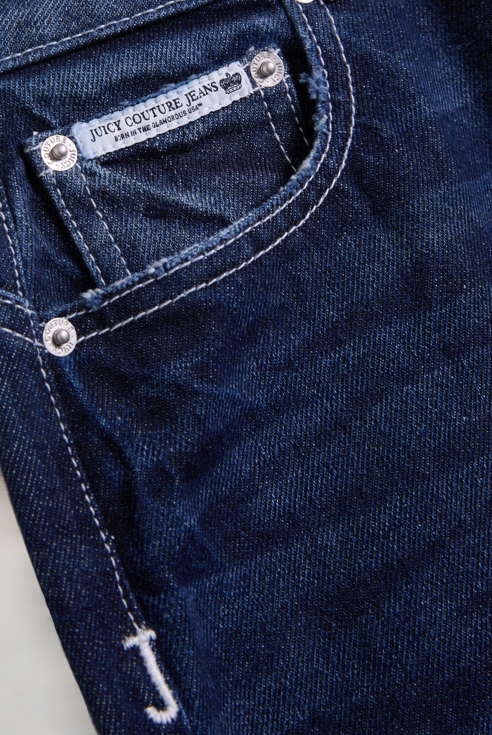 Displays the mid Wash 'Juicy' branded wide leg Diamanté jeans 