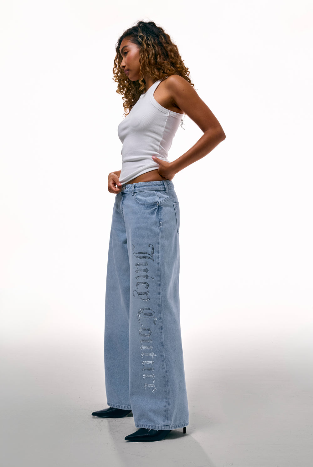 Displays a model wearing the Light Wash Diamanté 'Juicy' branded wide leg jeans 