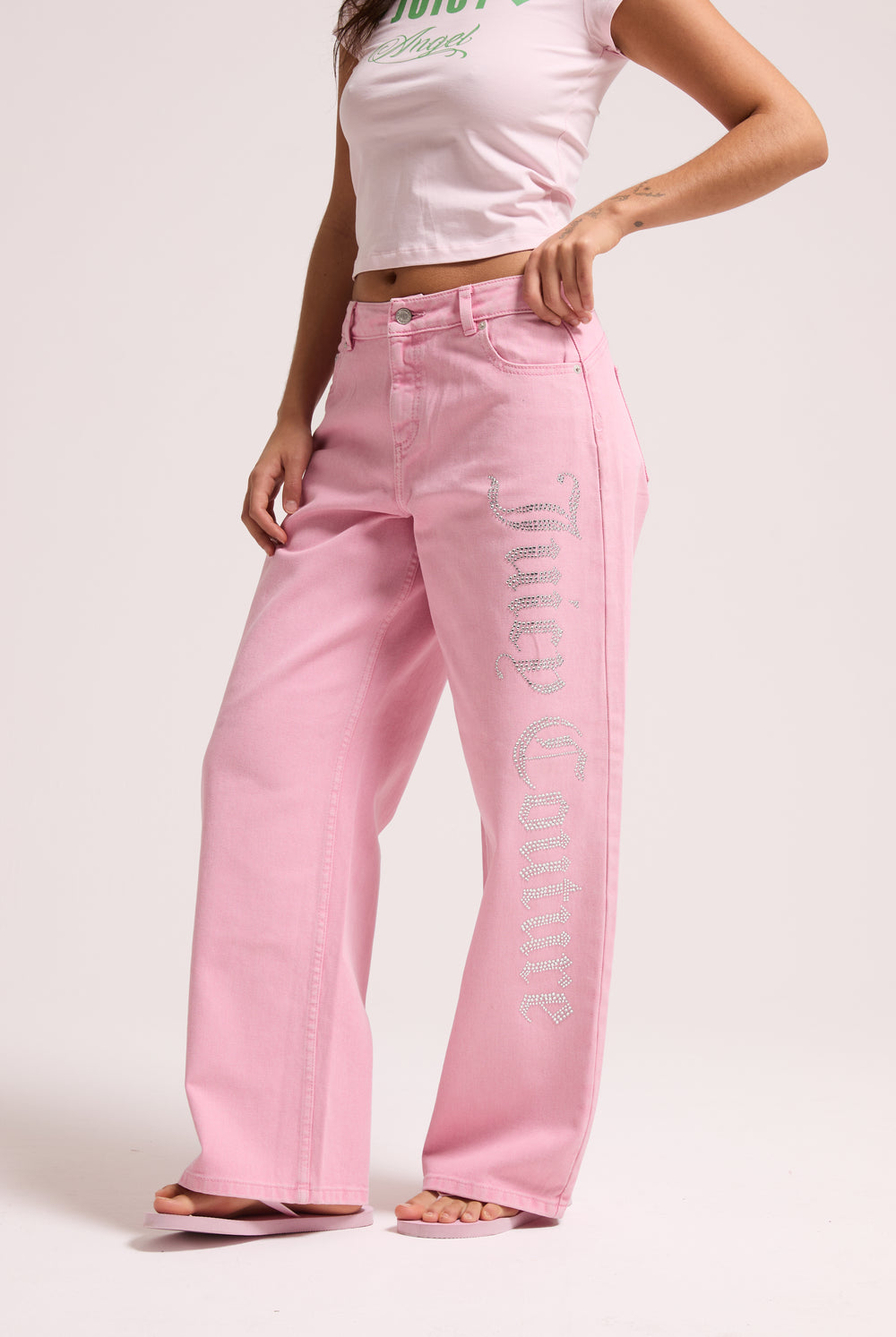 Displays a model wearing the Pink Wash 'Juicy' branded Diamanté wide leg jeans 
