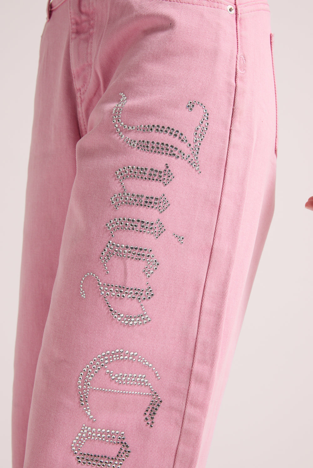 Displays a model wearing the Pink Wash 'Juicy' branded Diamanté wide leg jeans  featuring Juicy branding 