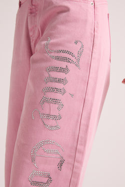Displays a model wearing the Pink Wash 'Juicy' branded Diamanté wide leg jeans  featuring Juicy branding 