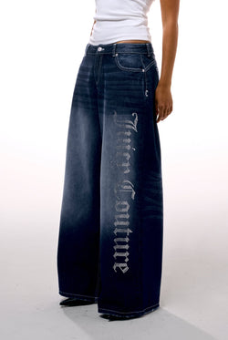 Displays a model wearing the mid Wash 'Juicy' branded wide leg Diamanté jeans 