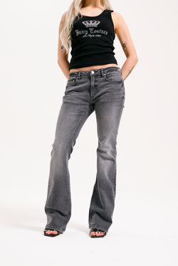 Displays a model wearing the grey wash 'Juicy' branded Digi diamanté mid rise flared jeans 