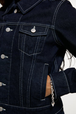 Displays a model wearing the Indigo Denim 'Juicy' branded Dog Crest Jacket