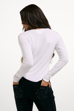 Displays a model wearing the White 'Juicy' branded Diamanté Dog Crest Long Sleeve T-Shirt