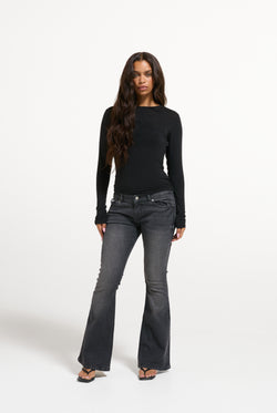 Displays a model wearing the Black 'Juicy' branded Diamanté Dog Crest Long Sleeve T-Shirt