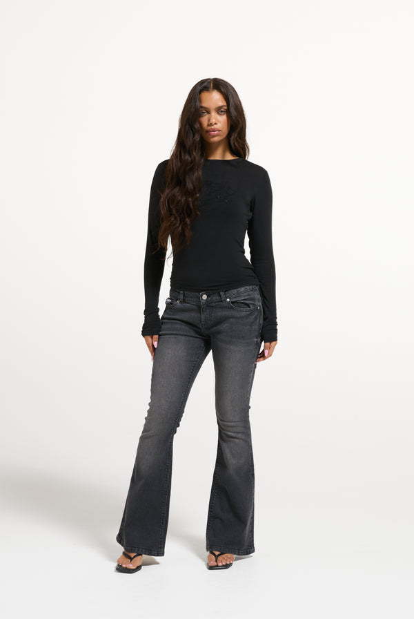 Displays a model wearing the Black 'Juicy' branded Diamanté Dog Crest Long Sleeve T-Shirt