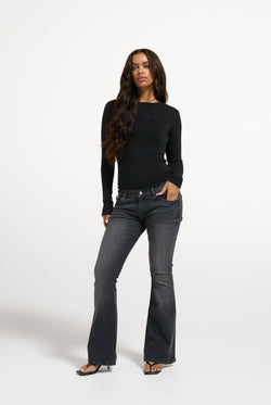 Displays a model wearing the Black 'Juicy' branded Diamanté Dog Crest Long Sleeve T-Shirt
