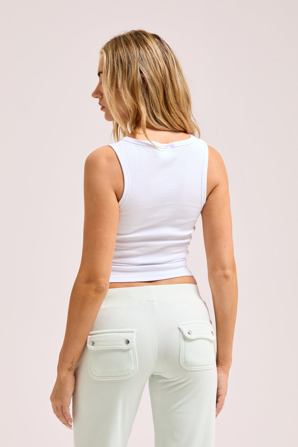 Displays a model wearing the White Diamanté 'Juicy' branded Dog Crest vest