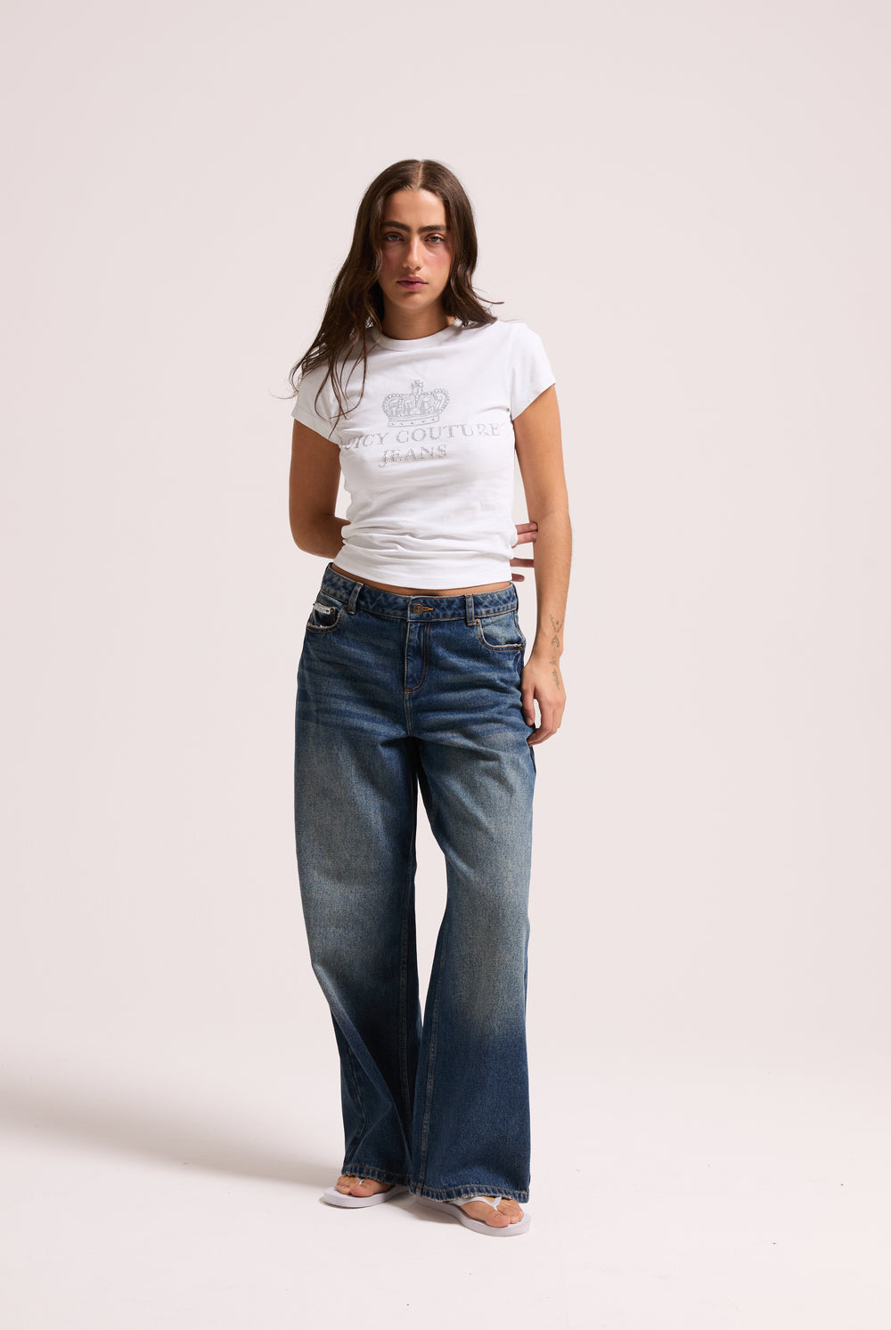 Displays a model wearing the vintage wash mid rise wide leg 'Juicy' branded jeans 