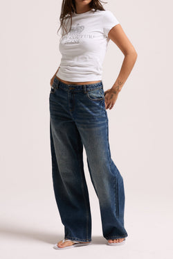 Displays a model wearing the vintage wash mid rise wide leg 'Juicy' branded jeans 