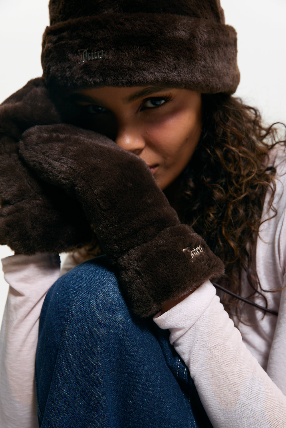 Displays a model wearing a pair of Java 'Juicy' branded Drawstring Fur Mittens