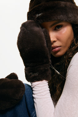 Displays a model wearing a pair of Java 'Juicy' branded Drawstring Fur Mittens