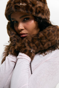 Displays a model wearing the Leopard Print 'Juicy' branded Drawstring Fur Mittens
