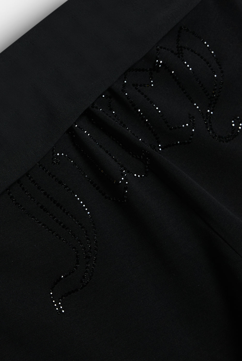 Displays the Black 'Juicy' branded Belted Flare Trousers featuring the juicy branding 