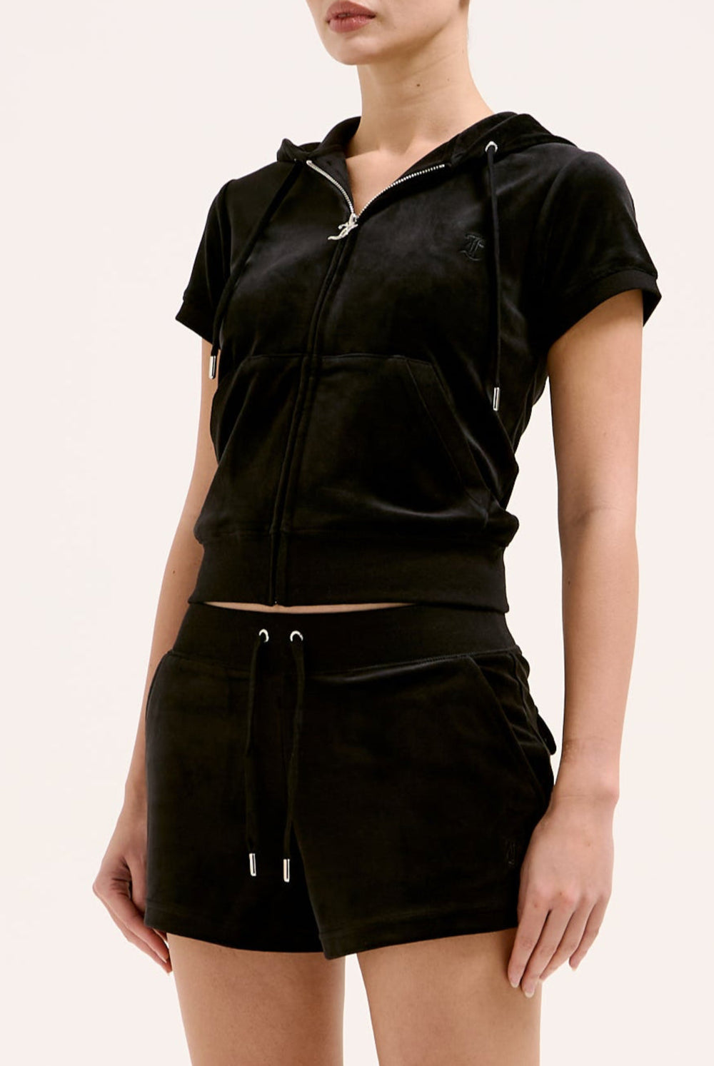 Displays a model wearing the Black 'Juicy' branded classic velour track short with back pocket 