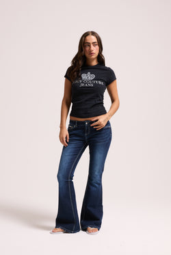 Displays a model wearing the 'Juicy' branded mid wash diamanté low rise flare jeans 
