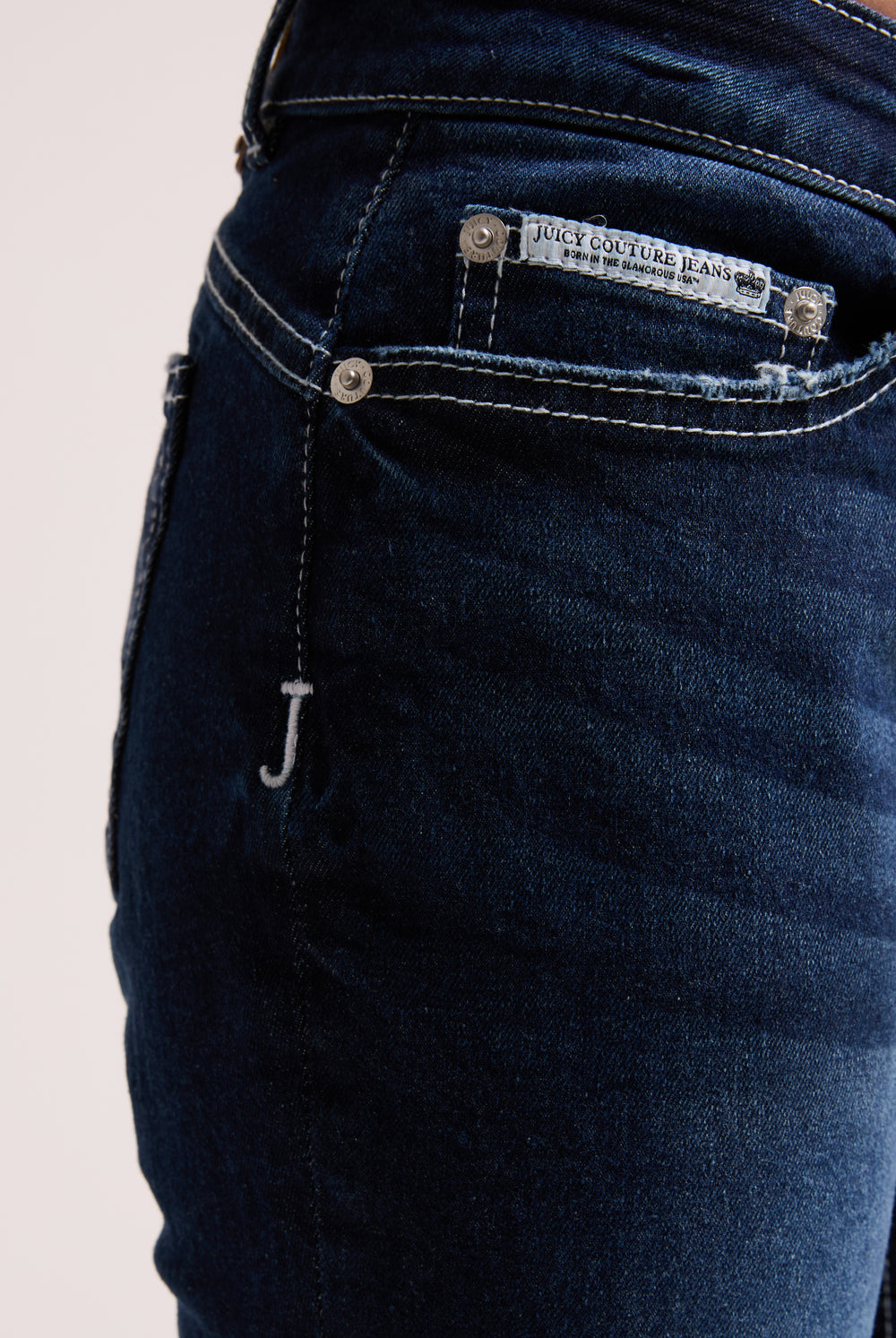 Displays the 'Juicy' branded mid wash diamanté low rise flare jeans 