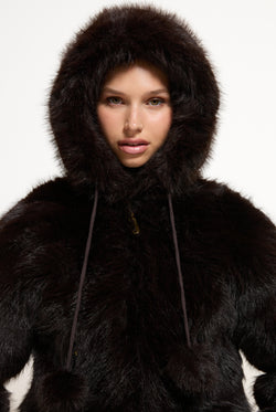 Displays a model wearing the Java 'Juicy' branded Hooded Faux Fur Jacket