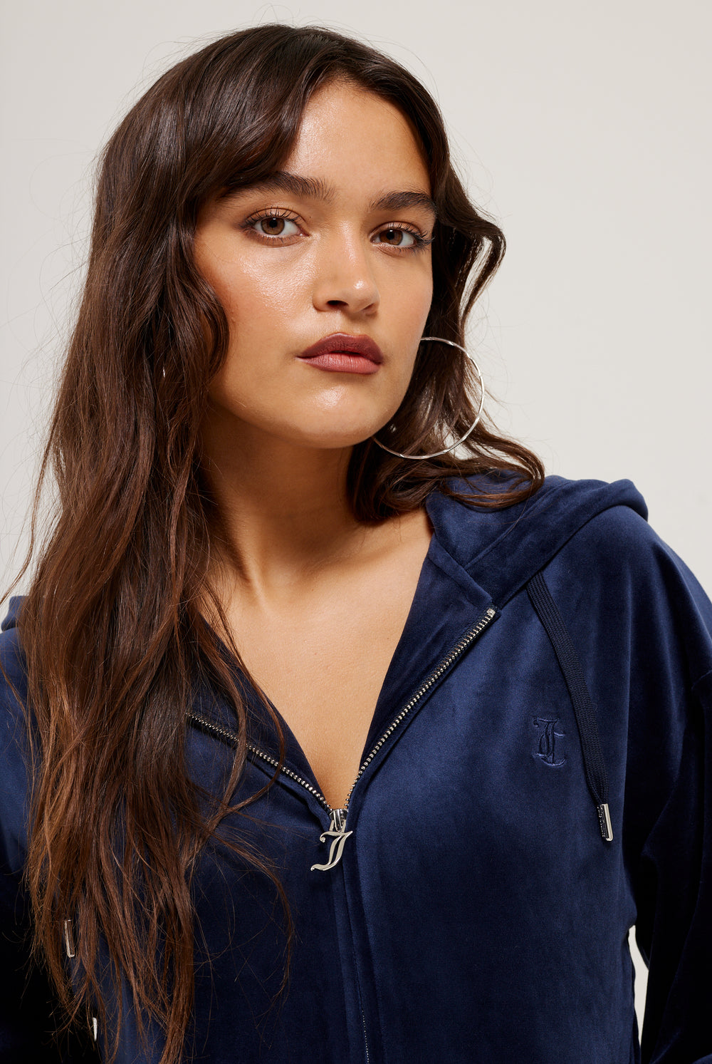 Displays a model wearing the Night Sky 'Juicy' branded classic velour oversized hoodie 