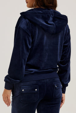 Displays a model wearing the Night Sky 'Juicy' branded classic velour oversized hoodie 