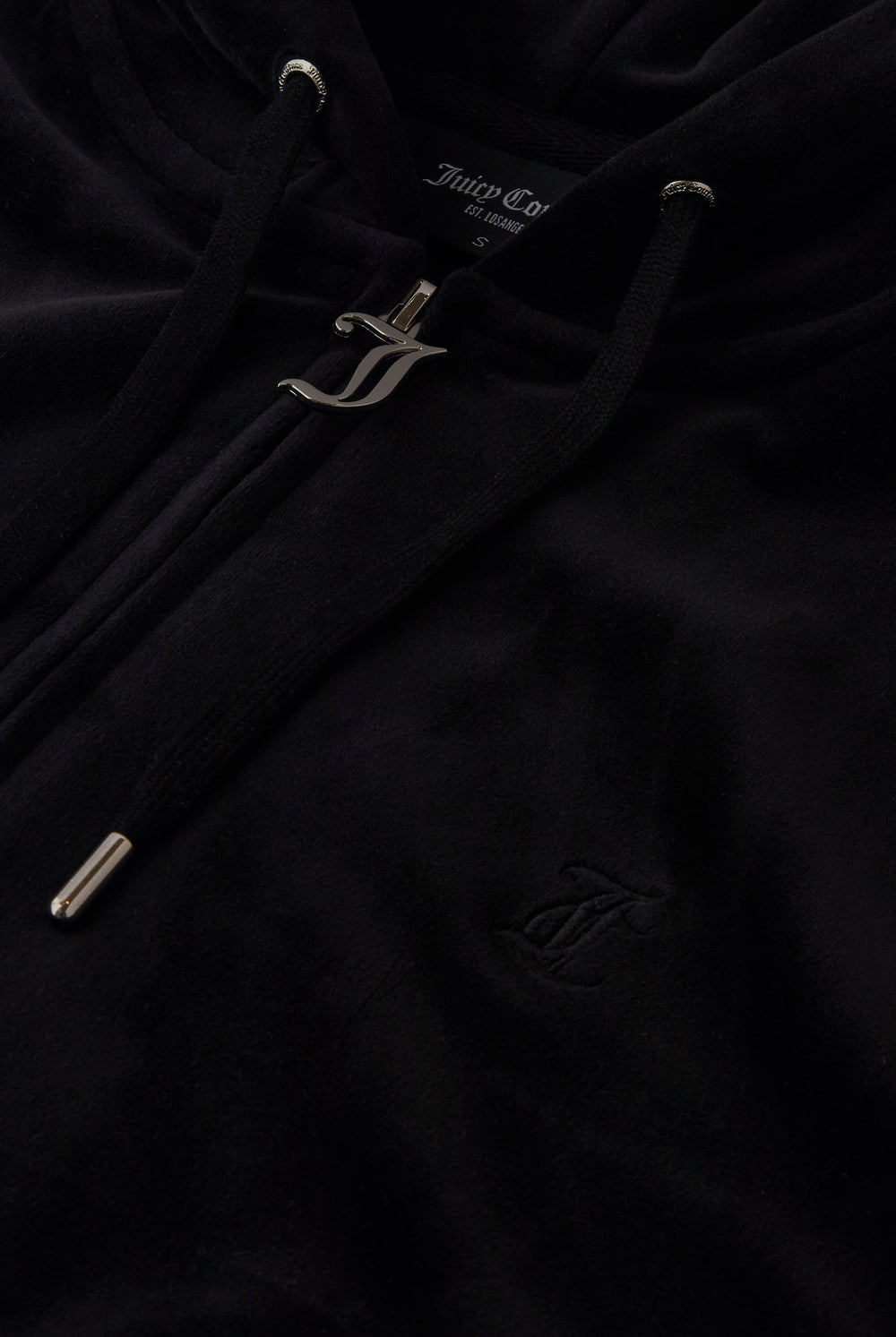 Displays the black classic 'Juicy' branded velour oversized hoodie featuring the juicy zip