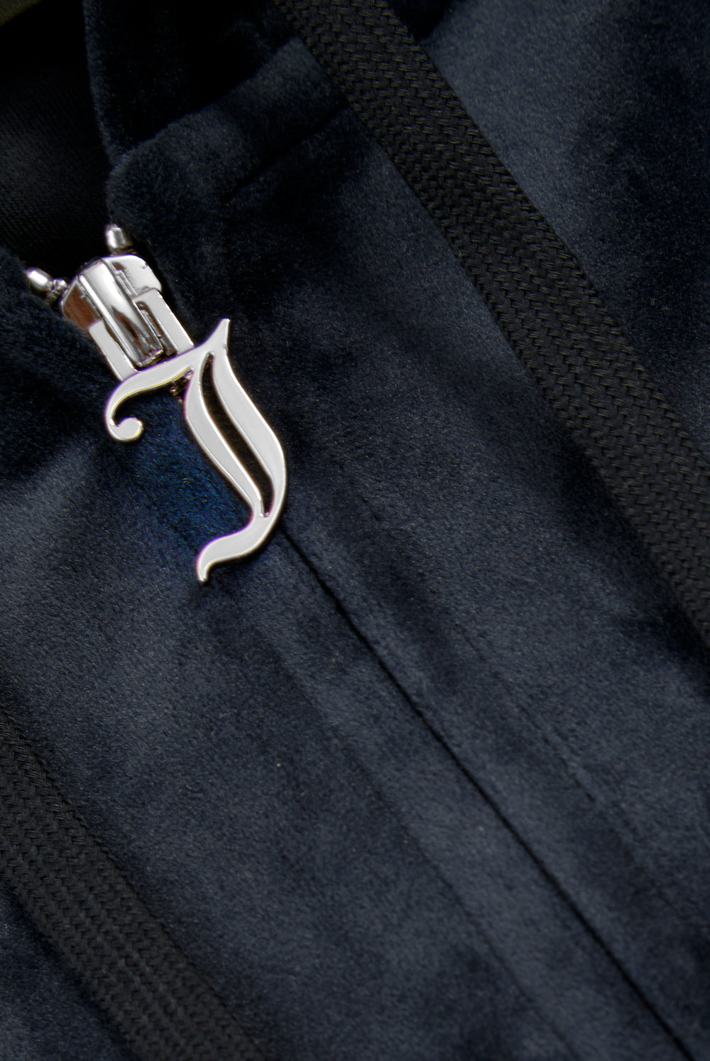 Displays a model wearing the Night Sky 'Juicy' branded classic velour oversized hoodie featuring the juicy branding on the zip