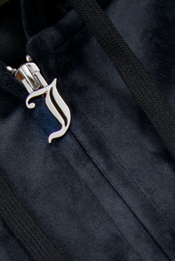 Displays a model wearing the Night Sky 'Juicy' branded classic velour oversized hoodie featuring the juicy branding on the zip