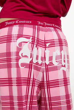 Displays a model wearing the Persian Red 'Juicy' branded Heiress Pyjama Set featuring the juicy branding 