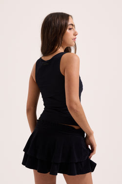 Displays a model wearing the Black Heritage 'Juicy' branded smoked tier skirt