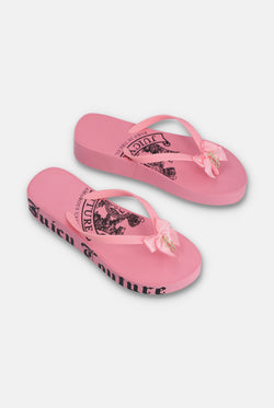 Displays a pair of the Pink 'Juicy' branded heritage wedge sliders 
