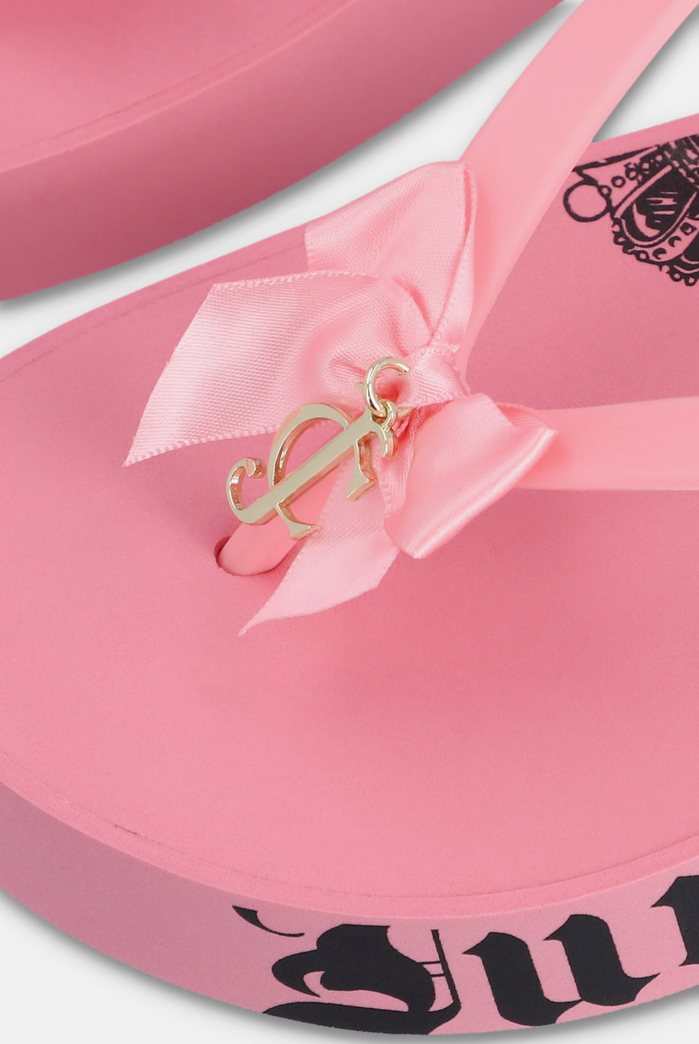 Displays the Pink 'Juicy' branded heritage wedge slider features a gold juicy Couture accessory 